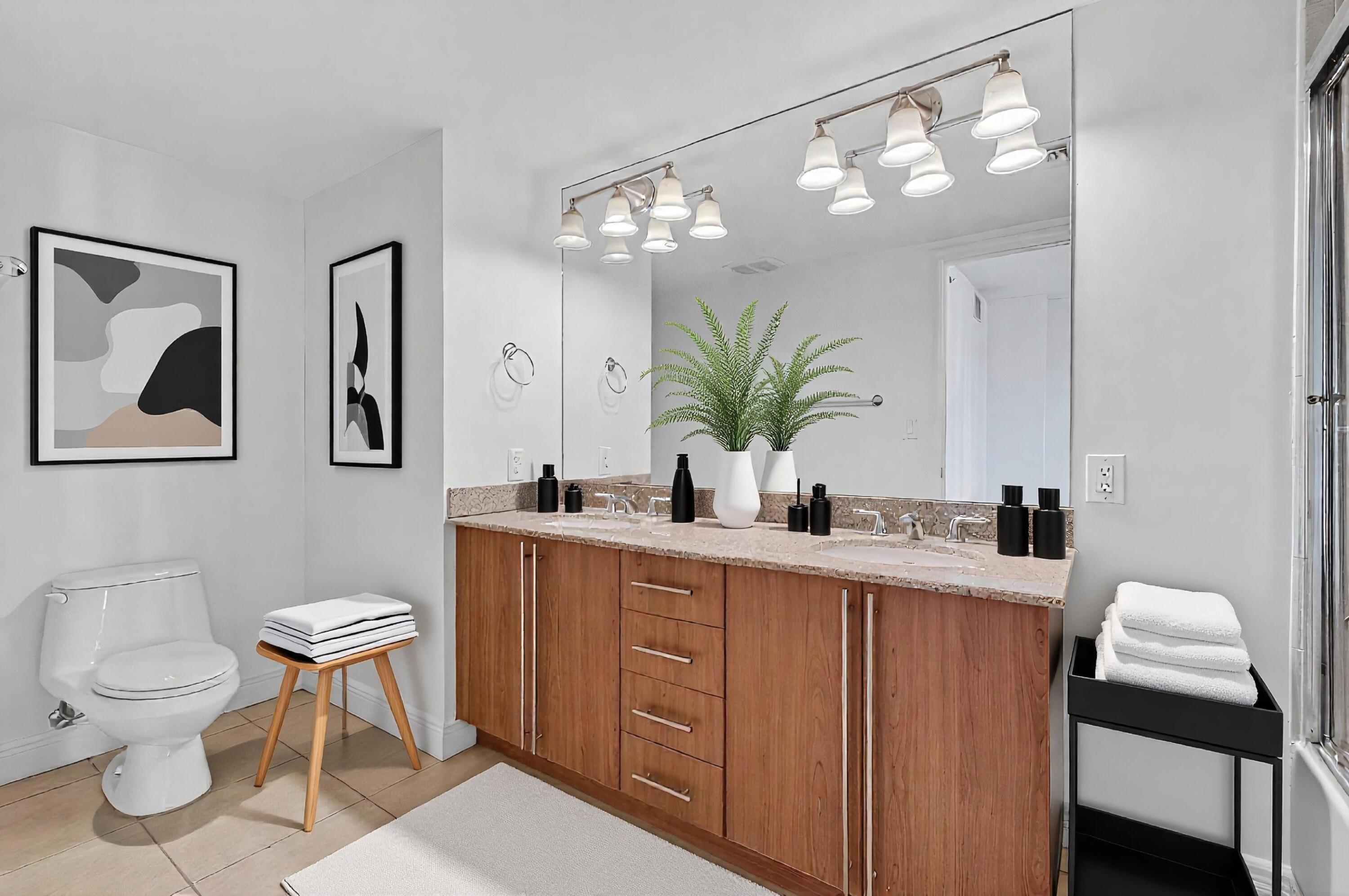 610 Clematis Street, Unit 532 West Palm Beach, FL 33401 - Photo 42 of 63 a bathroom with a toilet a sink and mirror