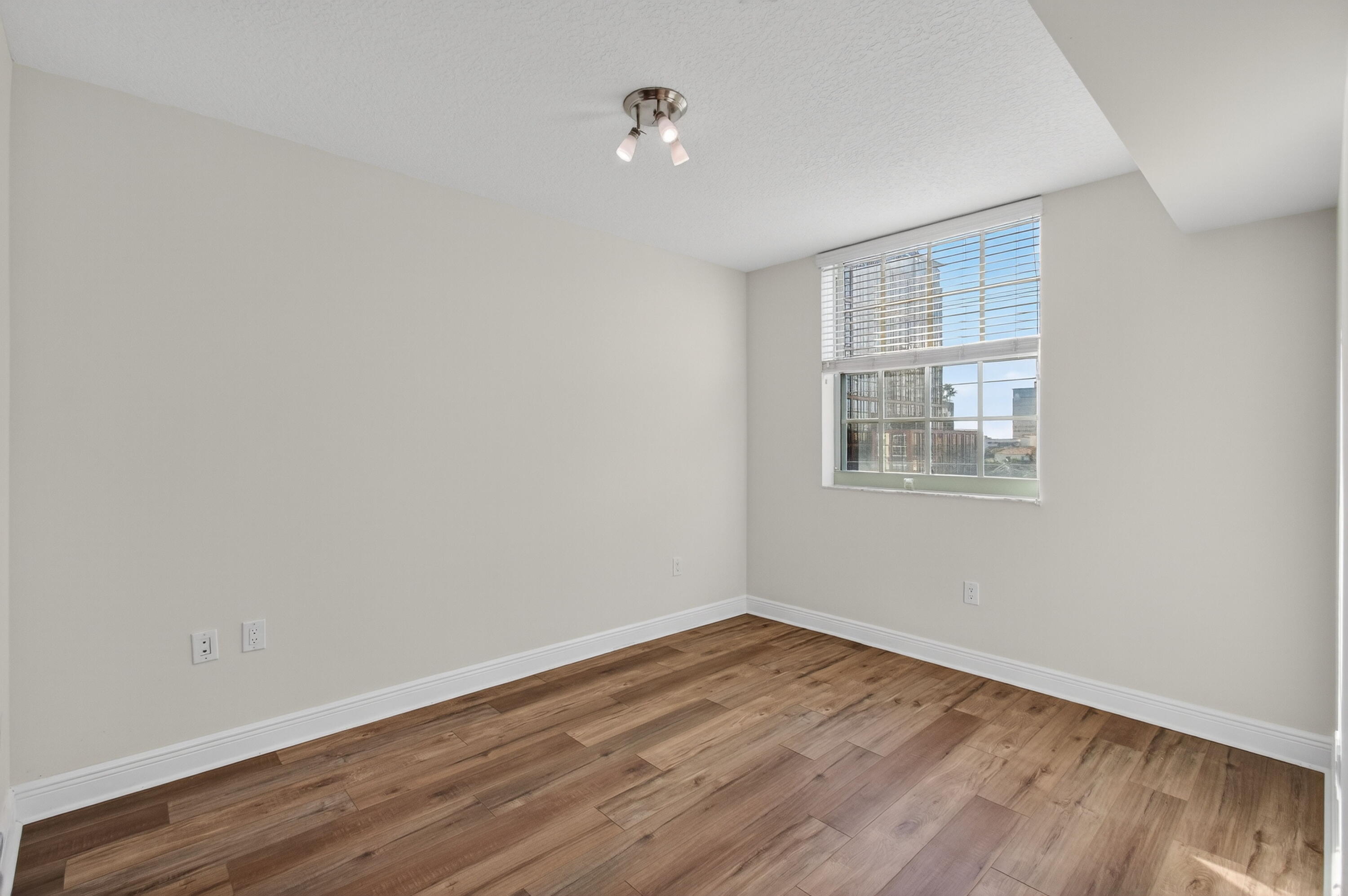 610 Clematis Street, Unit 532 West Palm Beach, FL 33401 - Photo 43 of 63 wooden floor in an empty room with a window