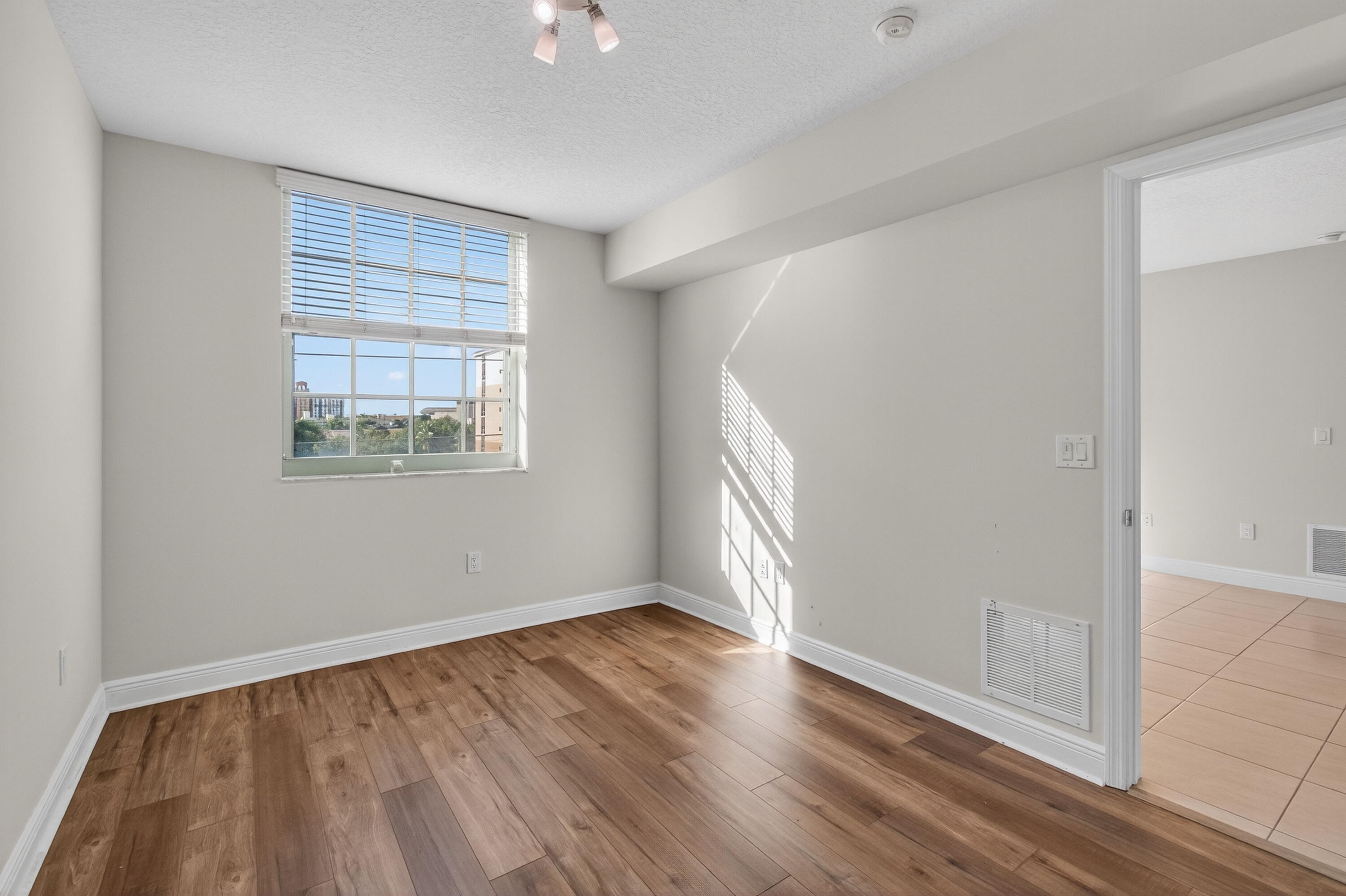 610 Clematis Street, Unit 532 West Palm Beach, FL 33401 - Photo 44 of 63 an empty room with wooden floor and windows