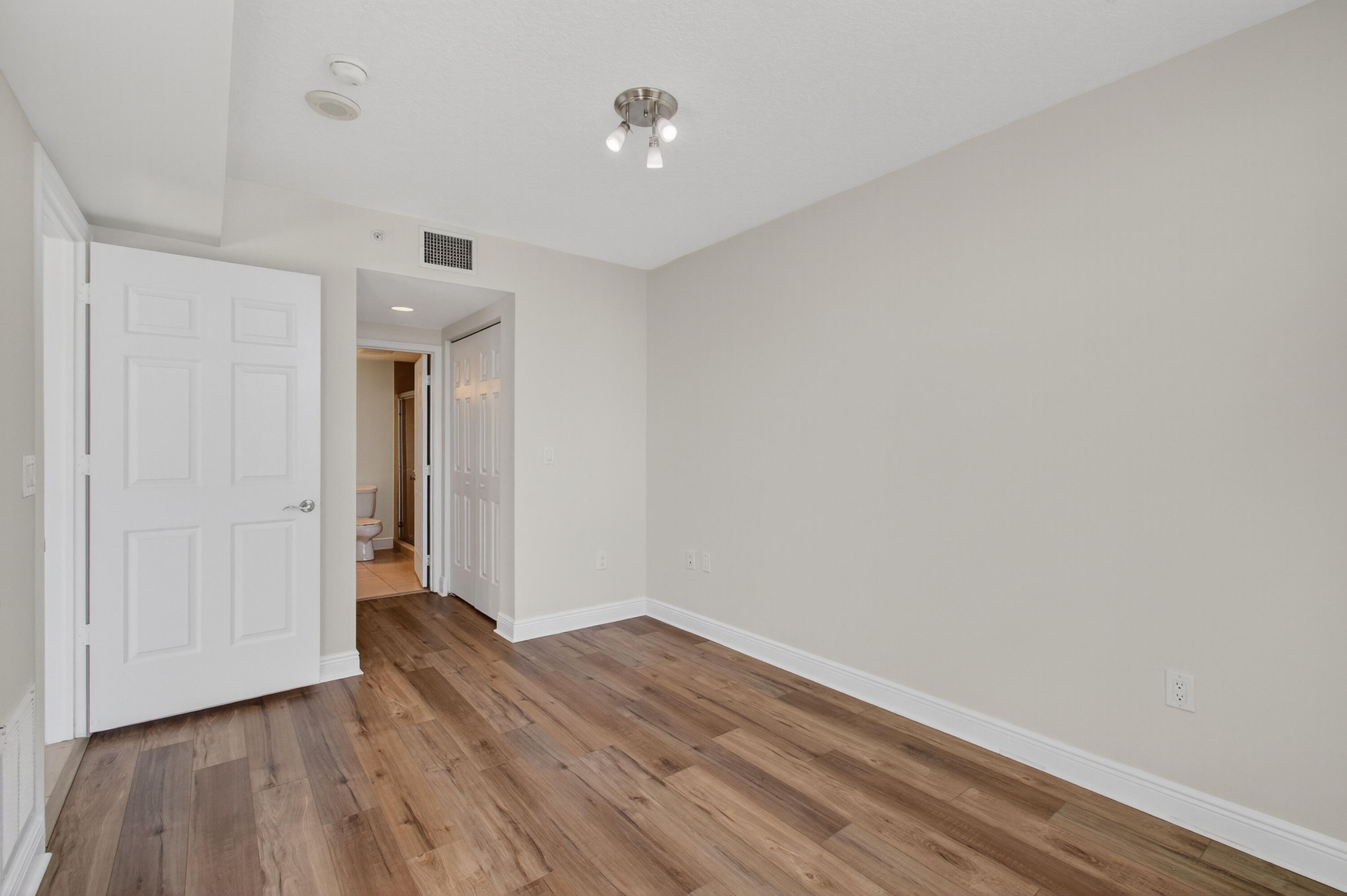 610 Clematis Street, Unit 532 West Palm Beach, FL 33401 - Photo 45 of 63 a view of an empty room with wooden floor