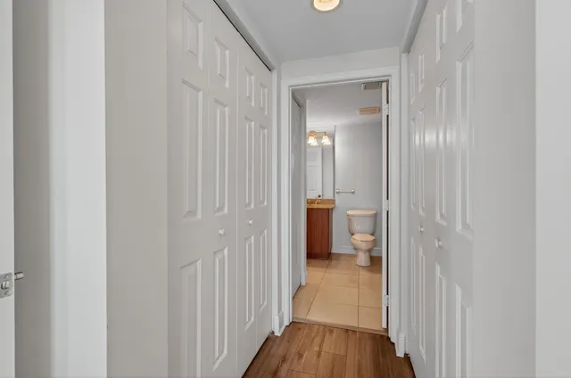 a view of living room with furniture and a clock