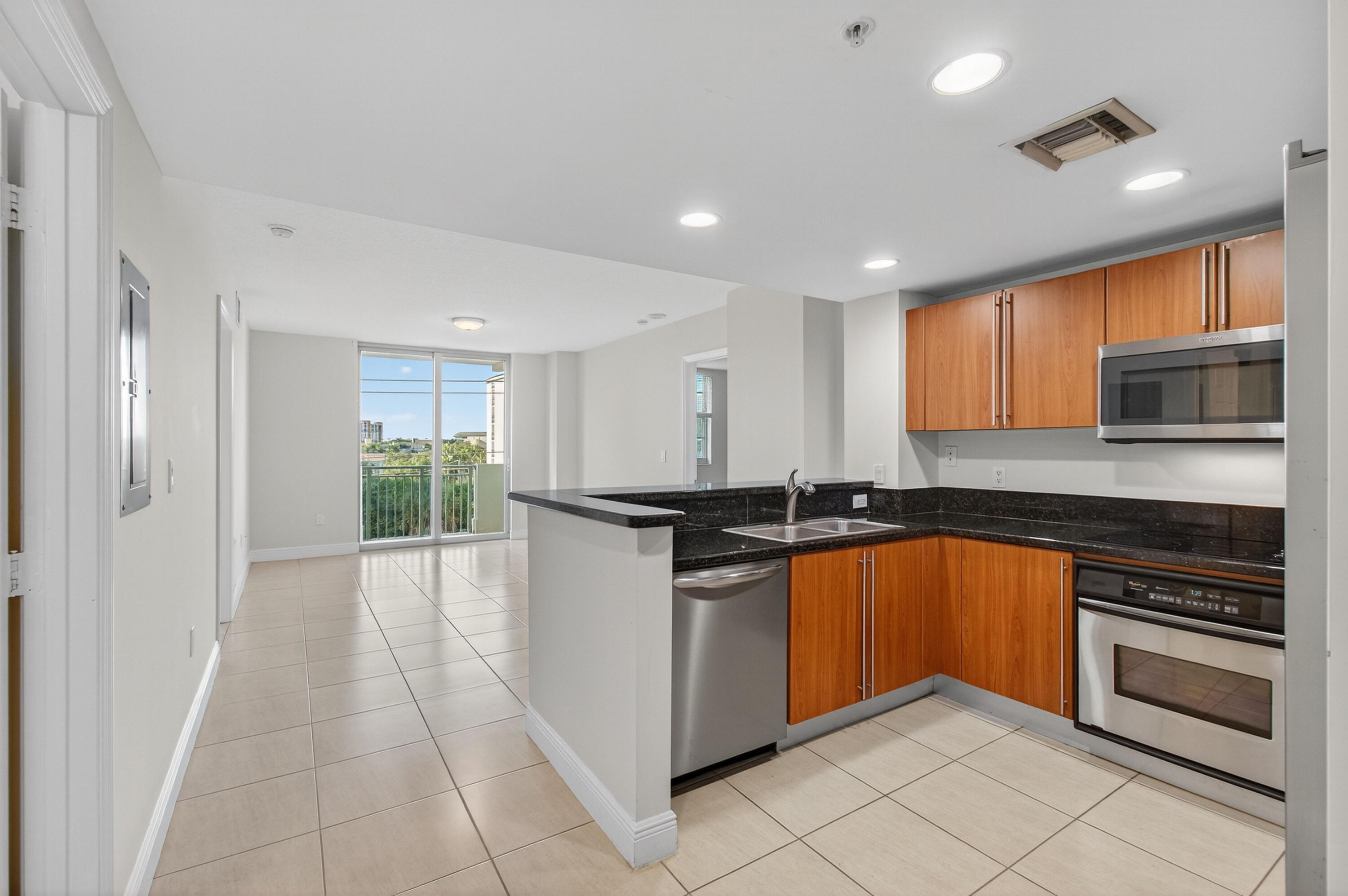 610 Clematis Street, Unit 532 West Palm Beach, FL 33401 - Photo 9 of 63 a kitchen with stainless steel appliances granite countertop a stove and a sink