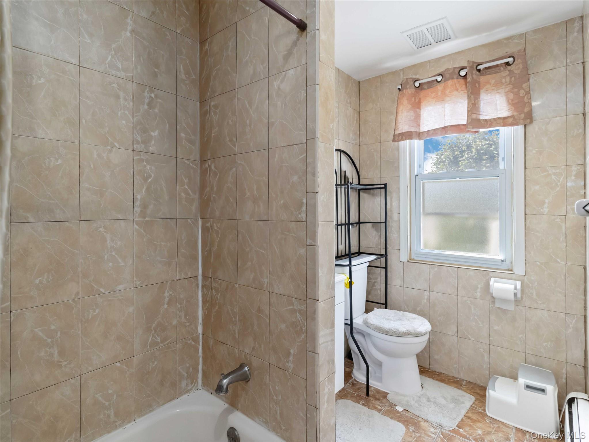 91-16 115th Street Queens, NY 11418 - Photo 12 of 19 a bathroom with a toilet and a shower