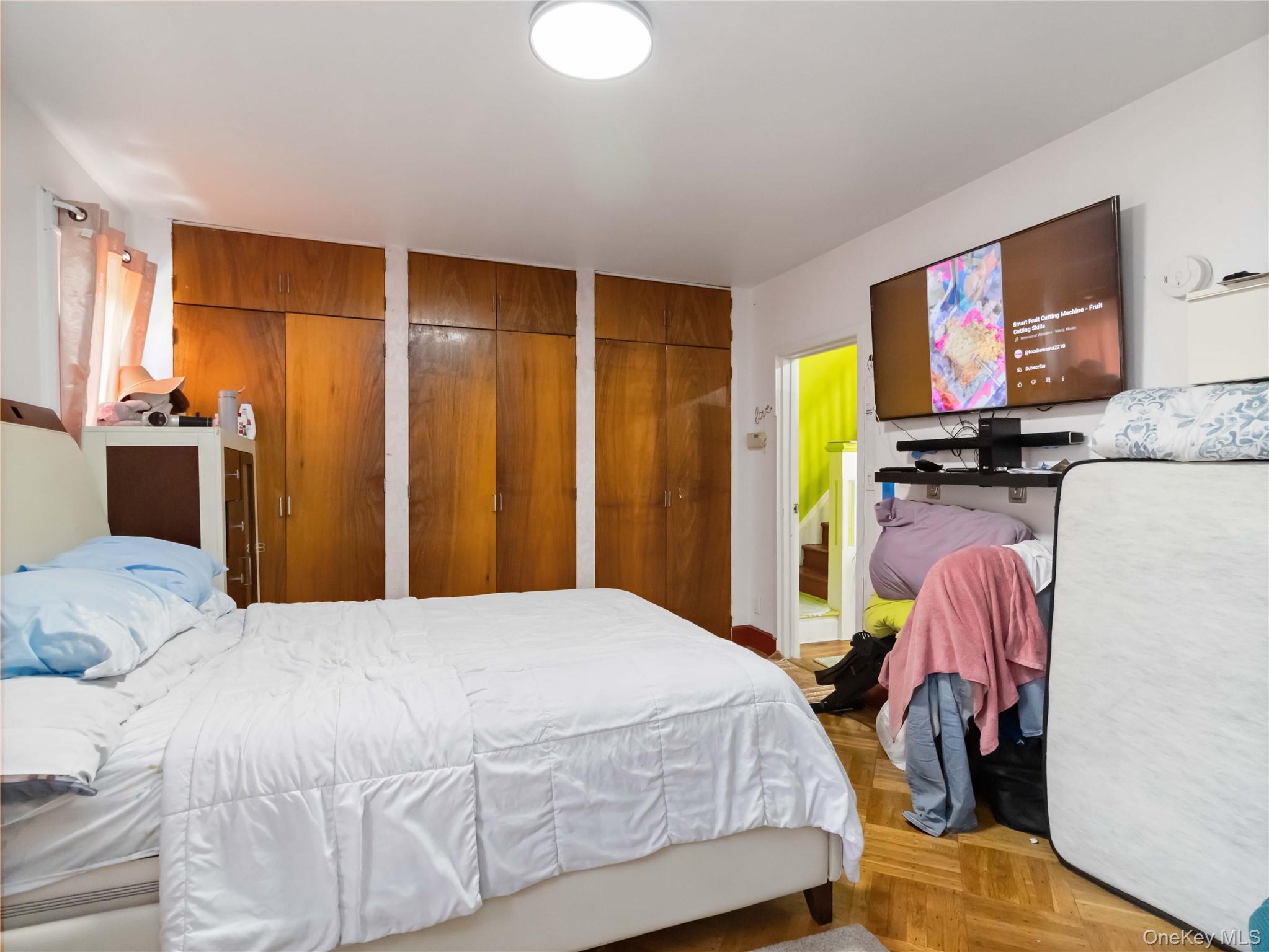 91-16 115th Street Queens, NY 11418 - Photo 13 of 19 a bedroom with a bed and a flat screen tv