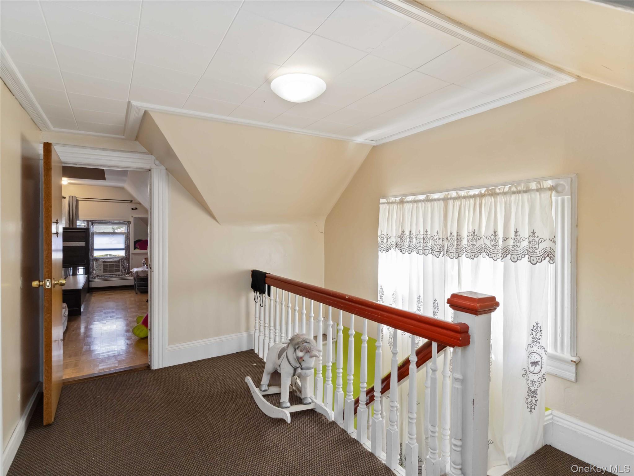 91-16 115th Street Queens, NY 11418 - Photo 14 of 19 a view of a hallway with a livingroom with wooden floor and windows