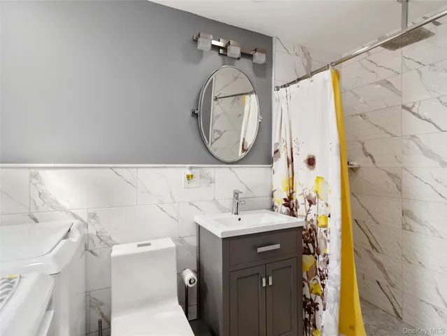 a bathroom with a sink mirror vanity and toilet