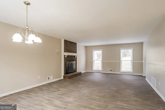 a view of a kitchen with wooden floor and a sink