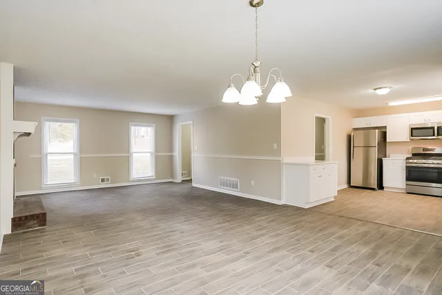 a kitchen with stainless steel appliances a refrigerator sink and stove top oven