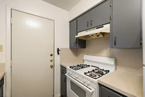 a kitchen with a stove and a refrigerator
