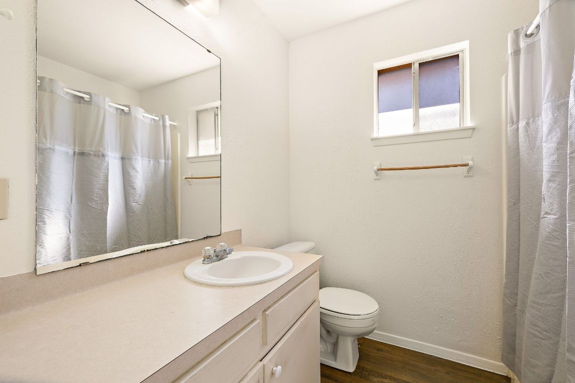 2402 Cottonwood Drive, Unit B Georgetown, TX 78628 - Photo 17 of 20 a bathroom with a sink a toilet and shower