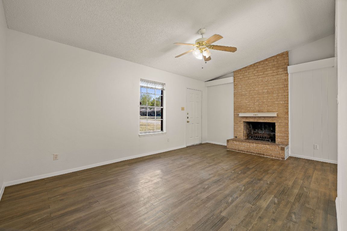 2402 Cottonwood Drive, Unit B Georgetown, TX 78628 - Photo 2 of 20 a view of an empty room with wooden floor and a window