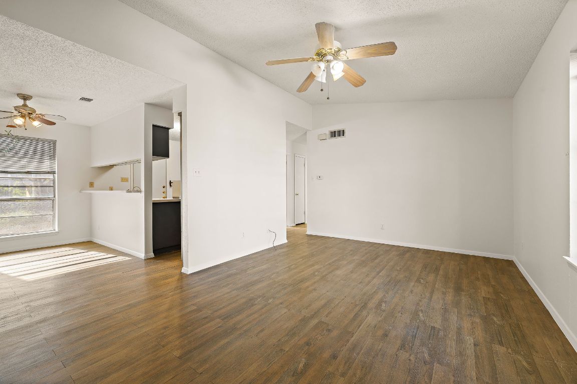 2402 Cottonwood Drive, Unit B Georgetown, TX 78628 - Photo 3 of 20 an empty room with wooden floor and ceiling fan