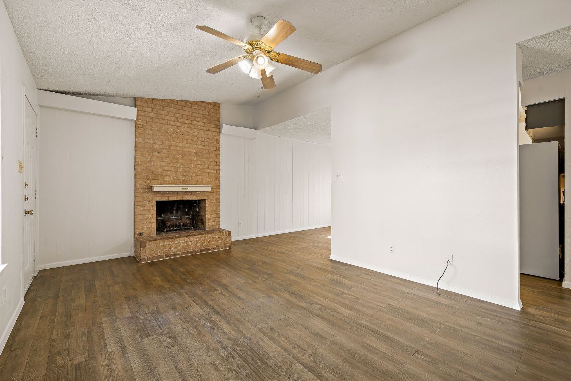 2402 Cottonwood Drive, Unit B Georgetown, TX 78628 - Photo 4 of 20 an empty room with wooden floor and chandelier fan