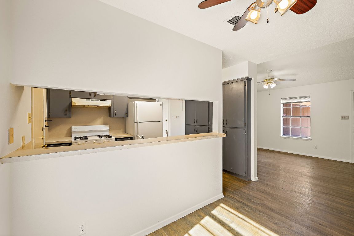 2402 Cottonwood Drive, Unit B Georgetown, TX 78628 - Photo 8 of 20 a kitchen with stainless steel appliances a refrigerator and a stove top oven
