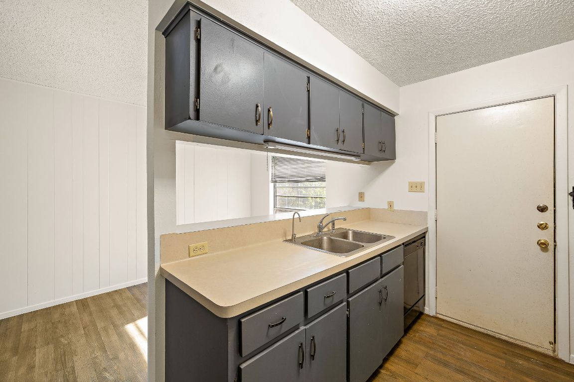 2402 Cottonwood Drive, Unit B Georgetown, TX 78628 - Photo 10 of 20 a kitchen with a sink cabinets and wooden floor