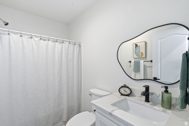 502 West 725 North Logan, UT 84321 - Photo 16 of 25 Full bathroom featuring vanity and a shower with curtain