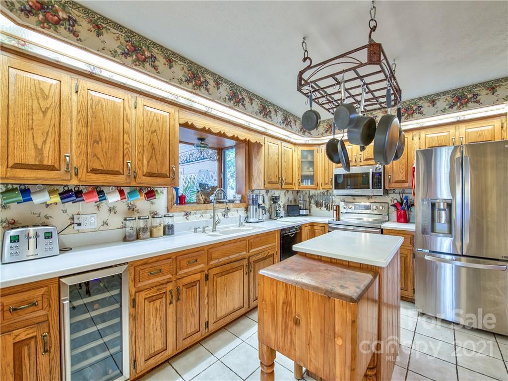 17 Royal Ridge Road Clyde, NC 28721 - Photo 18 of 38 a kitchen with stainless steel appliances granite countertop a sink and cabinets