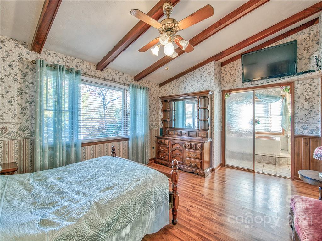 17 Royal Ridge Road Clyde, NC 28721 - Photo 22 of 38 a bedroom with a bed and wooden floor
