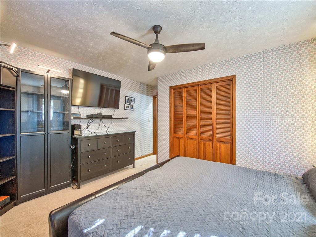 17 Royal Ridge Road Clyde, NC 28721 - Photo 25 of 38 a bed room with a bed and flat screen tv