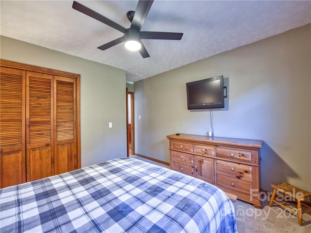17 Royal Ridge Road Clyde, NC 28721 - Photo 28 of 38 a bedroom with a bed and a flat screen tv