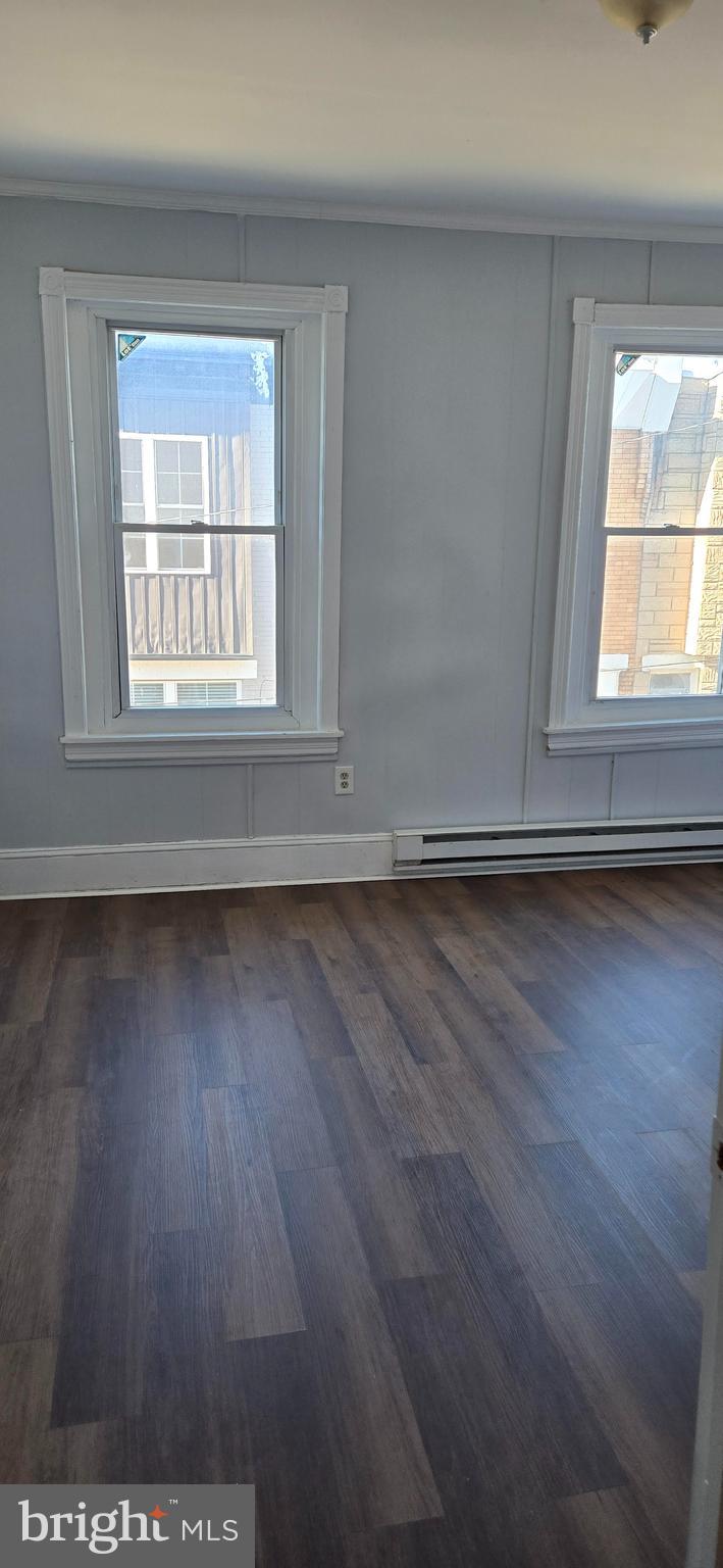 1609 South LeCount Street Philadelphia, PA 19145 - Photo 12 of 12 an empty room with wooden floor and windows