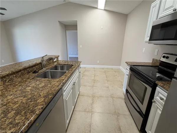 a kitchen that has a sink and a stove