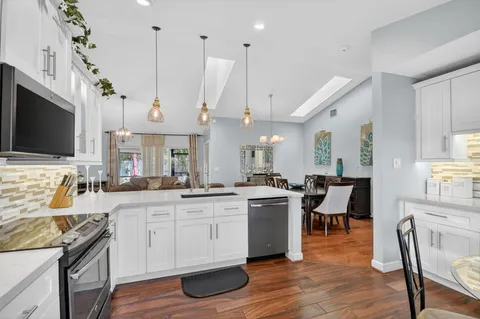 a large kitchen with a table and chairs