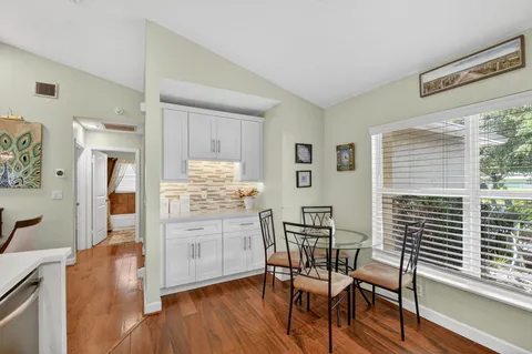 a dining room with furniture and wooden floor