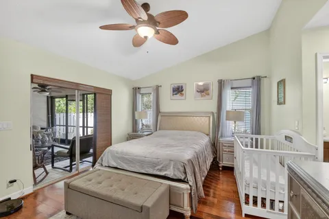 a bedroom with a bed and a large window with the outer view