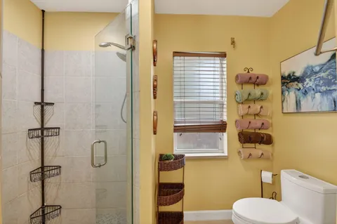 a bathroom with a toilet and a shower