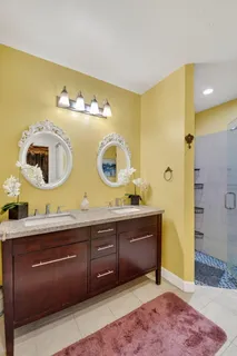 a spacious bathroom with a double vanity sink and a mirror