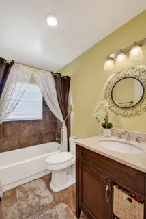 a bathroom with a sink a toilet and bathtub