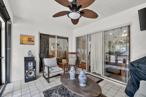 a living room with furniture and a floor to ceiling window