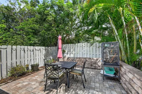 a view of outdoor dining space with a table and chairs