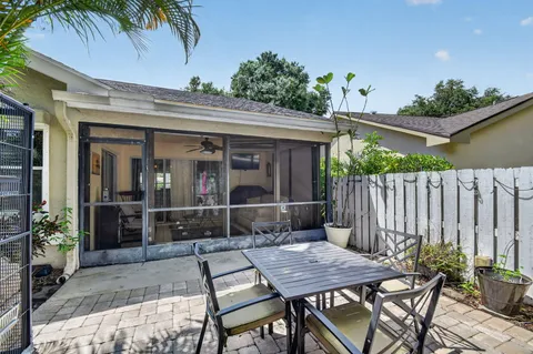 a backyard of a house with barbeque oven table and chairs
