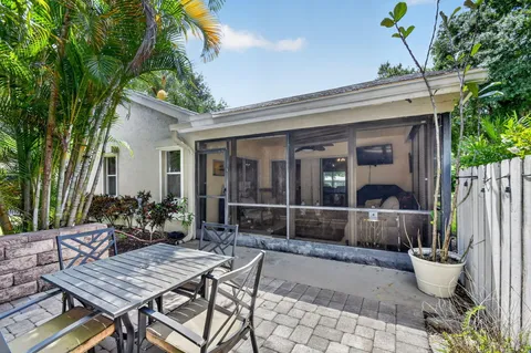 a view of house with patio and outdoor seating