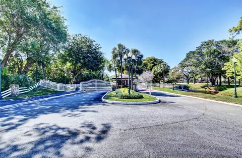 a view of a fountain with large trees