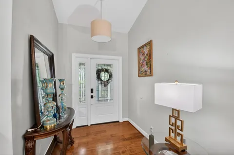 a view of an entryway with furniture and wooden floor
