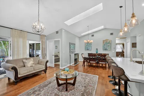 a living room with furniture chandelier and a table