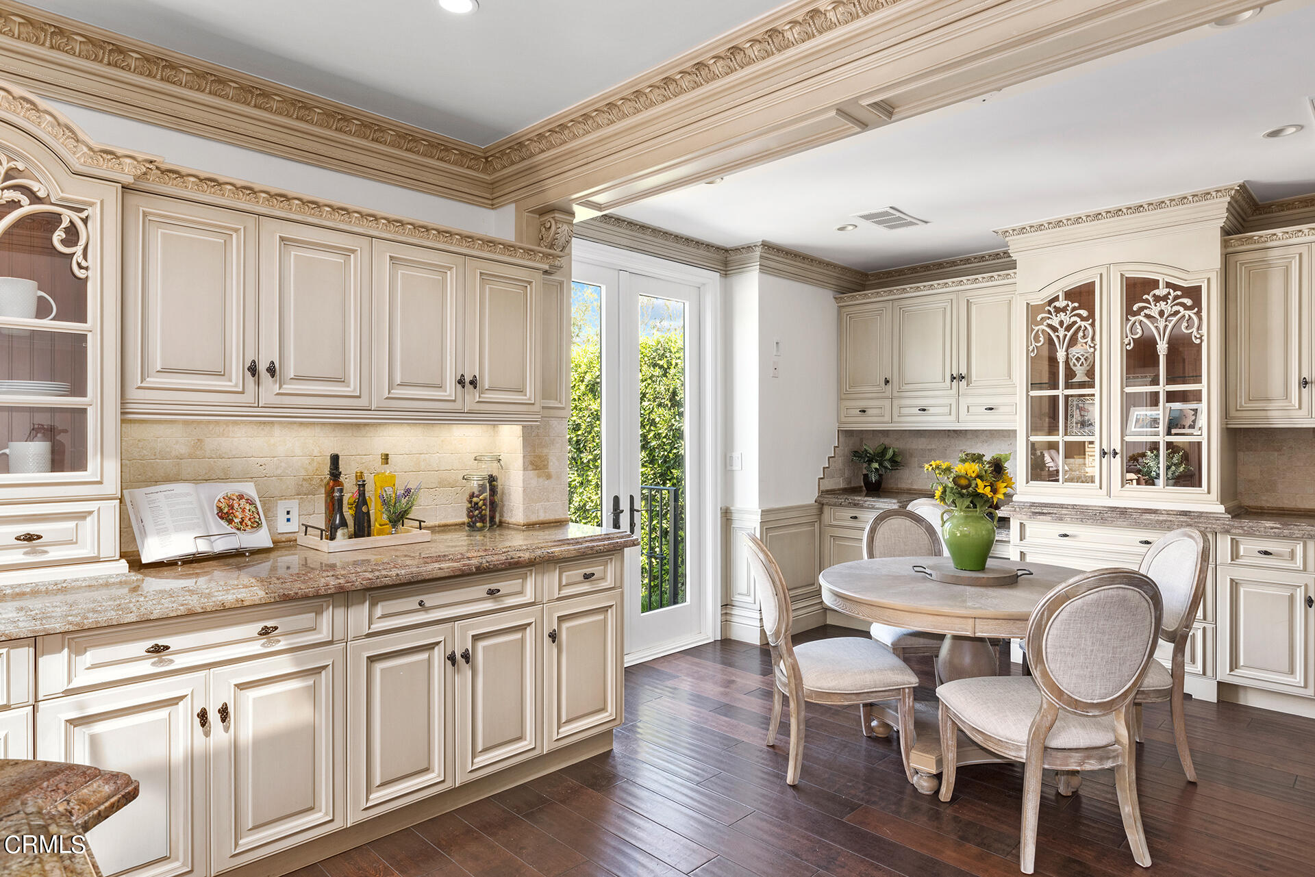 506 North Crescent Drive Beverly Hills, CA 90210 - Photo 18 of 36 a kitchen with granite countertop a dining table chairs and cabinets