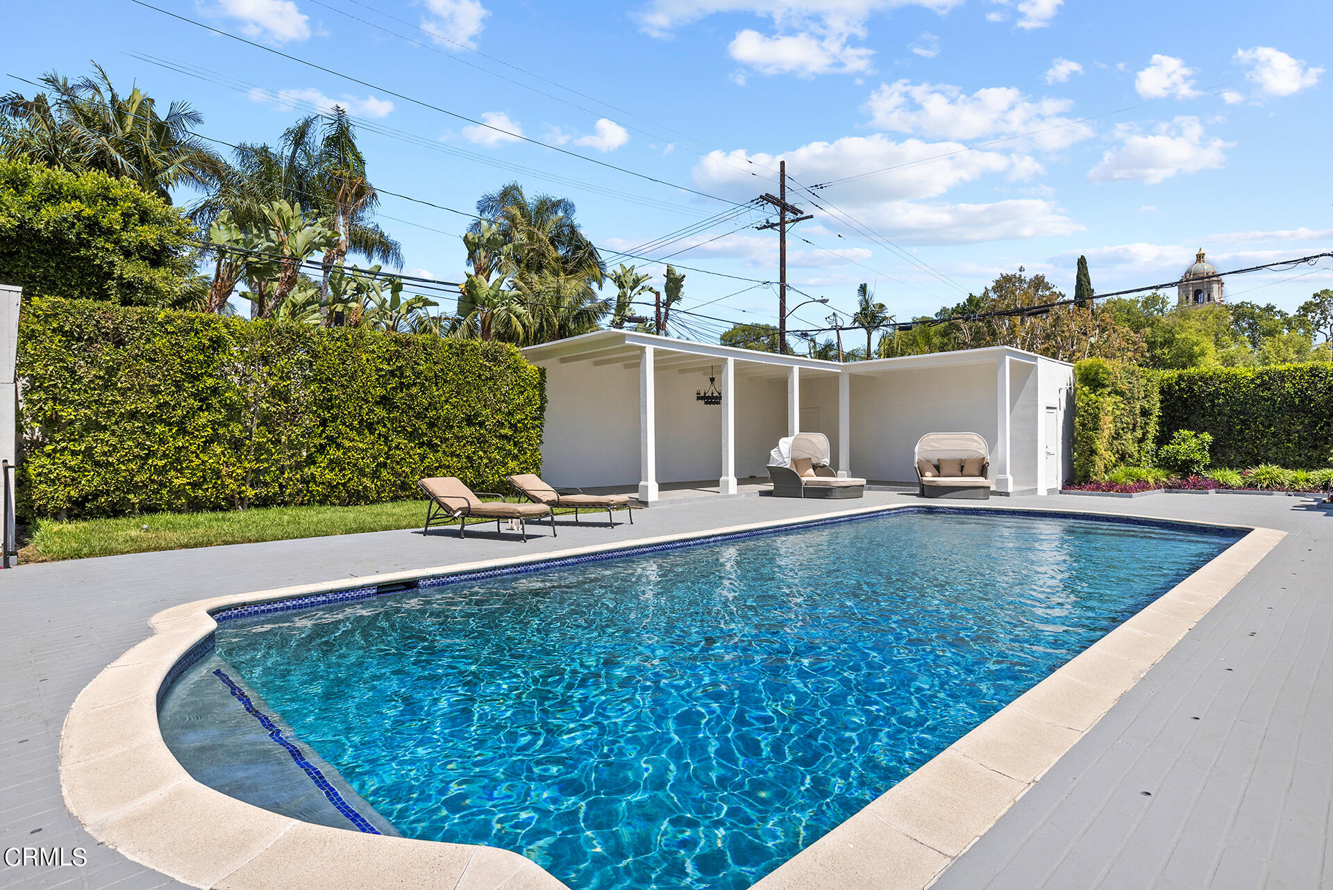 506 North Crescent Drive Beverly Hills, CA 90210 - Photo 34 of 36 a view of a swimming pool with a chairs and tables in the patio