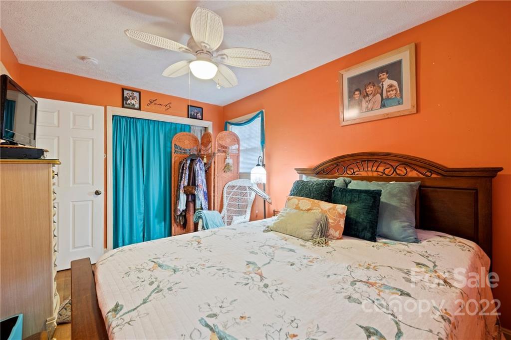 2 Pinehurst Road Asheville, NC 28805 - Photo 27 of 48 a bedroom with a bed and a chandelier