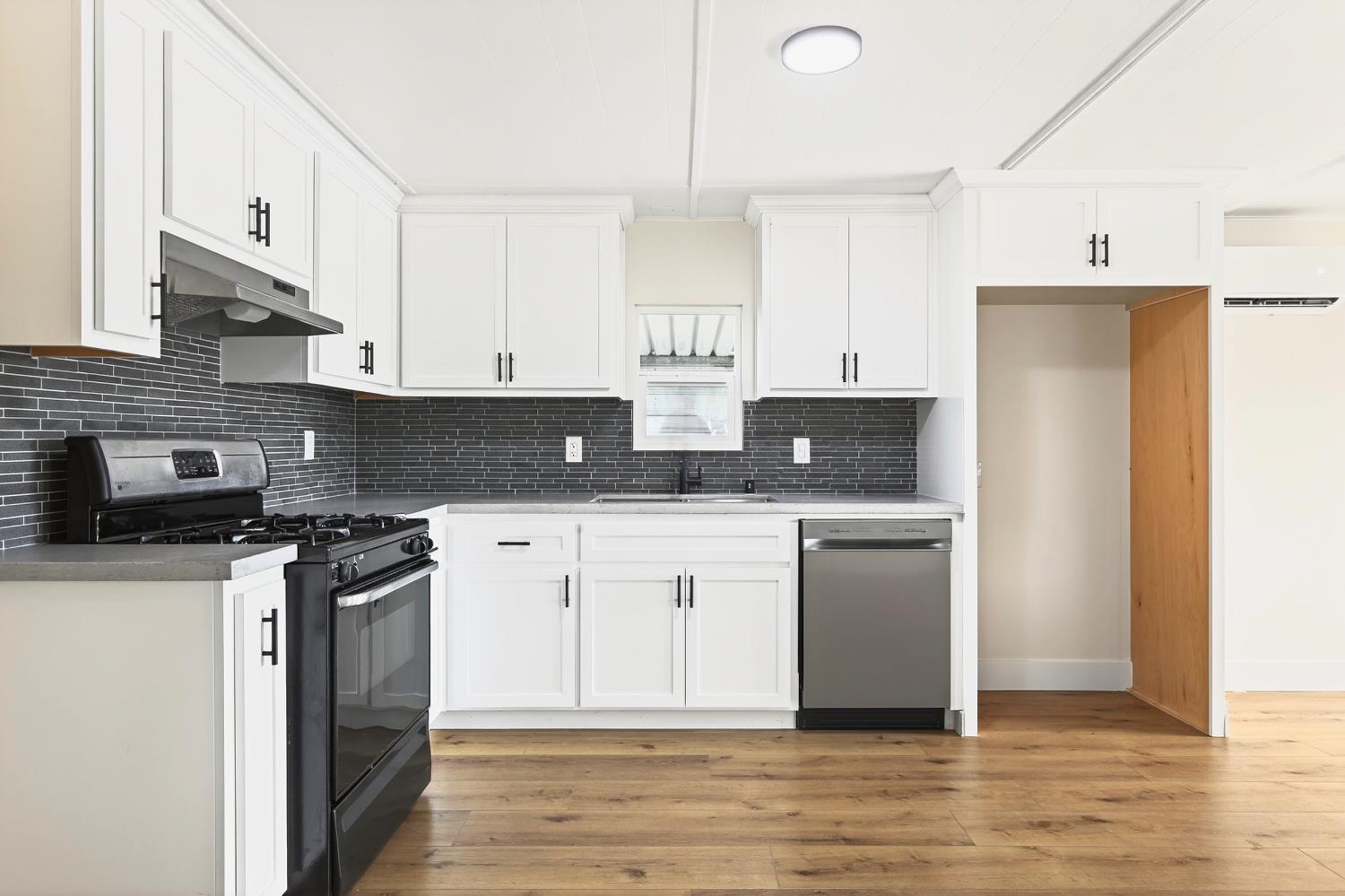 3435 Marfargoa, Unit 48 Stockton, CA 95215 - Photo 12 of 22 a kitchen with stainless steel appliances granite countertop a stove a refrigerator a sink a stove and white cabinets