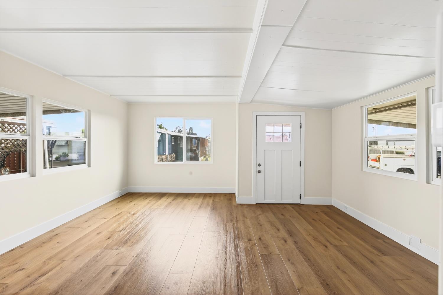 3435 Marfargoa, Unit 48 Stockton, CA 95215 - Photo 14 of 22 a view of an empty room with wooden floor and a window
