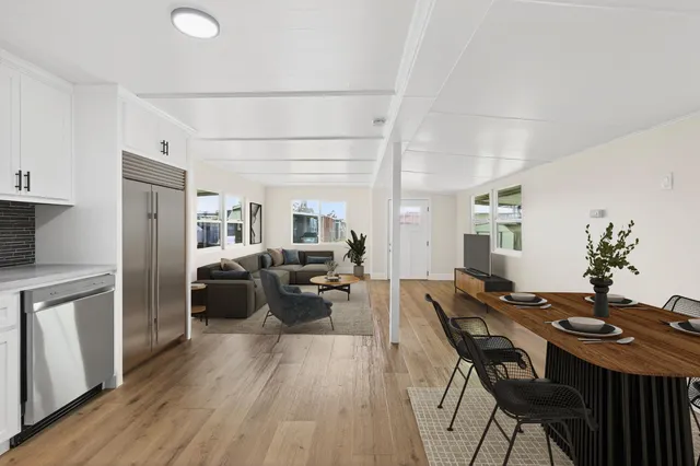 a living room with furniture dining table and wooden floor