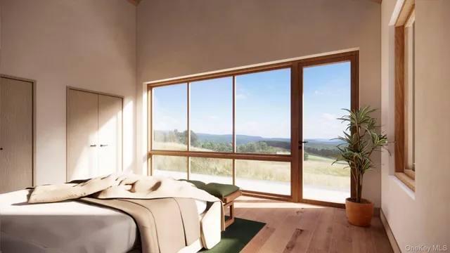 a bedroom with a large bed and a large window with wooden floor