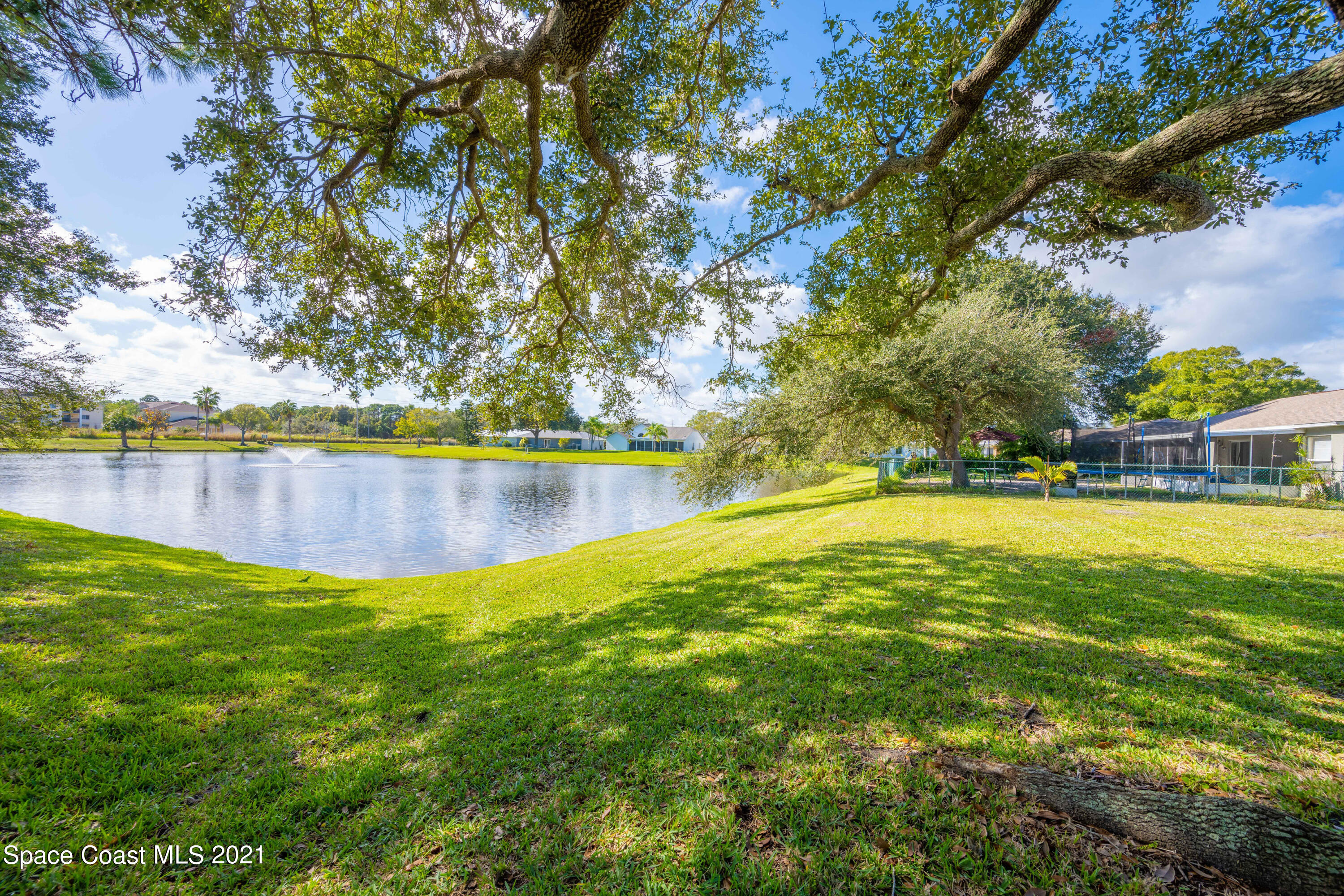 265 Oak Lake Road Melbourne, FL 32901 - Photo 2 of 25 a view of yard with swimming pool and seating