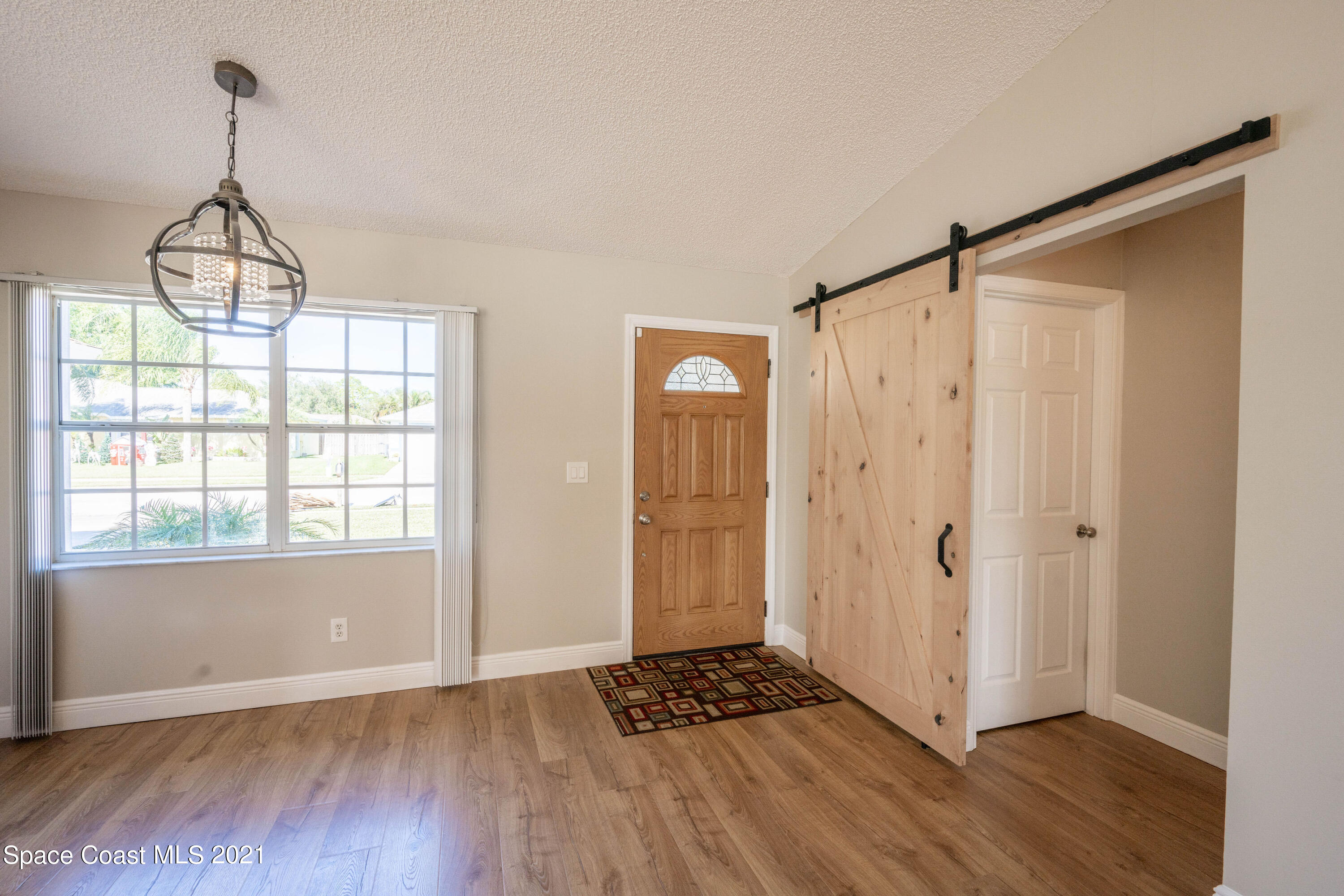 265 Oak Lake Road Melbourne, FL 32901 - Photo 16 of 25 a view of an empty room with window and wooden floor