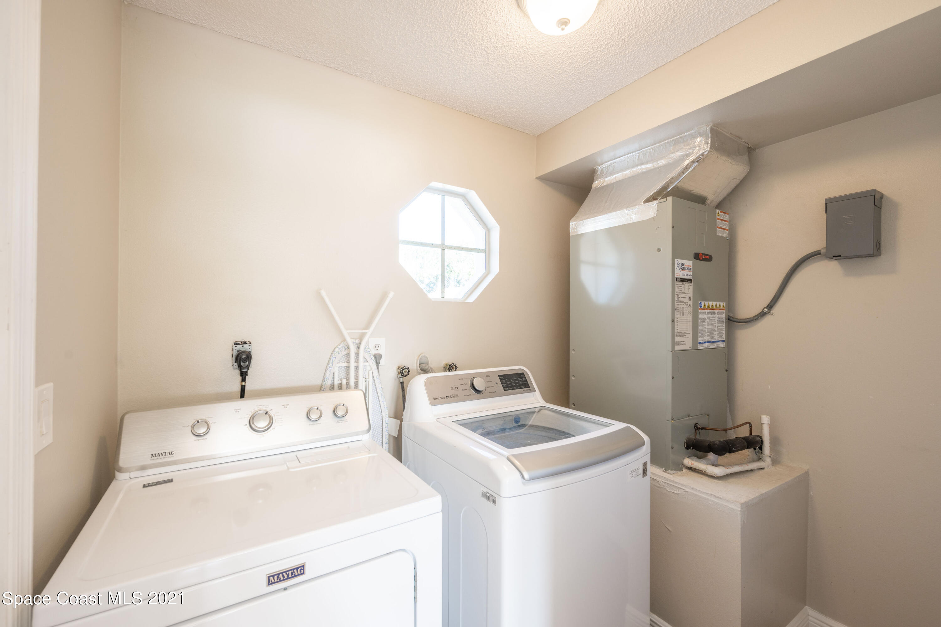 265 Oak Lake Road Melbourne, FL 32901 - Photo 17 of 25 a view of washer and dryer with bathroom in the background