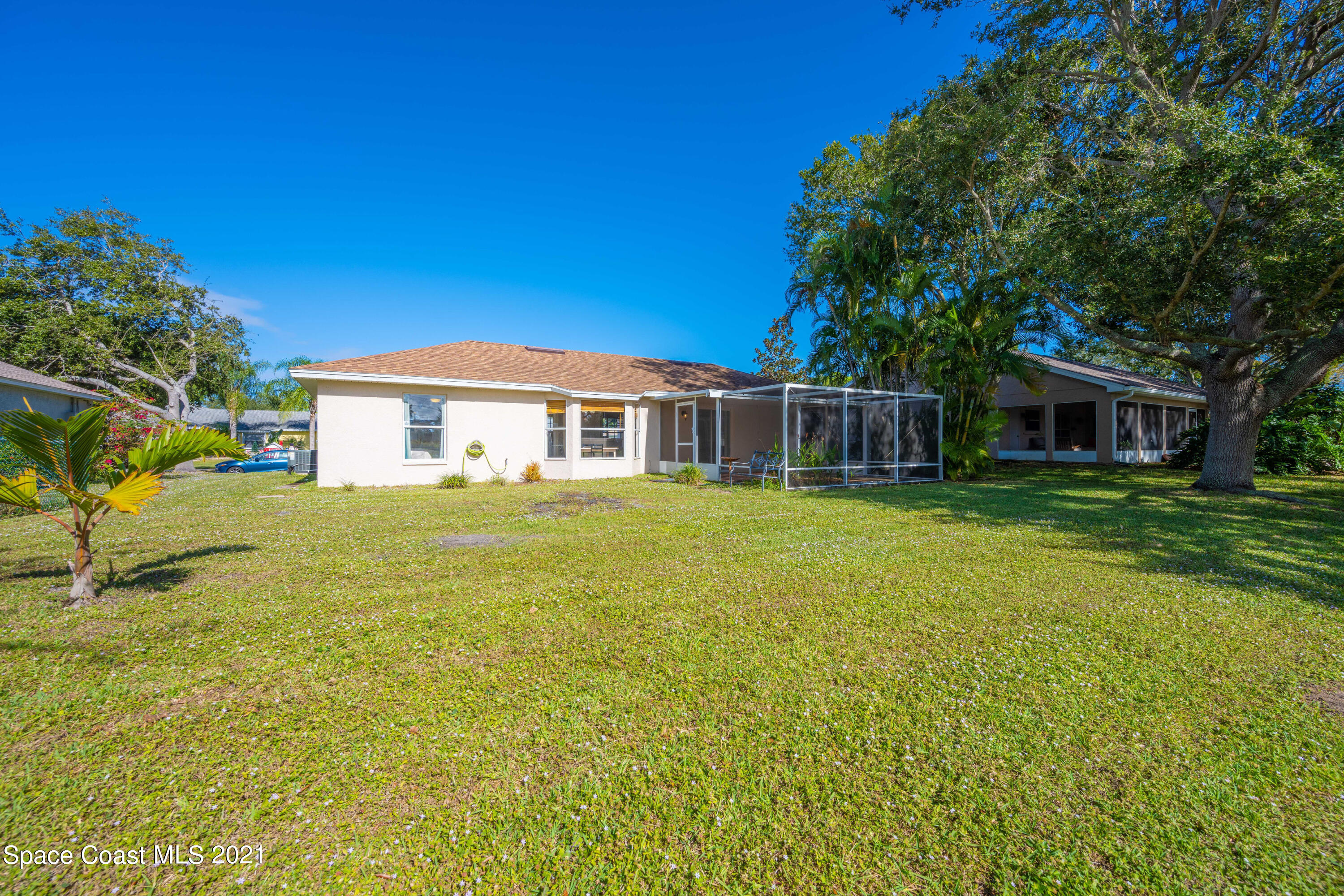 265 Oak Lake Road Melbourne, FL 32901 - Photo 25 of 25 a house with swimming pool in front of it